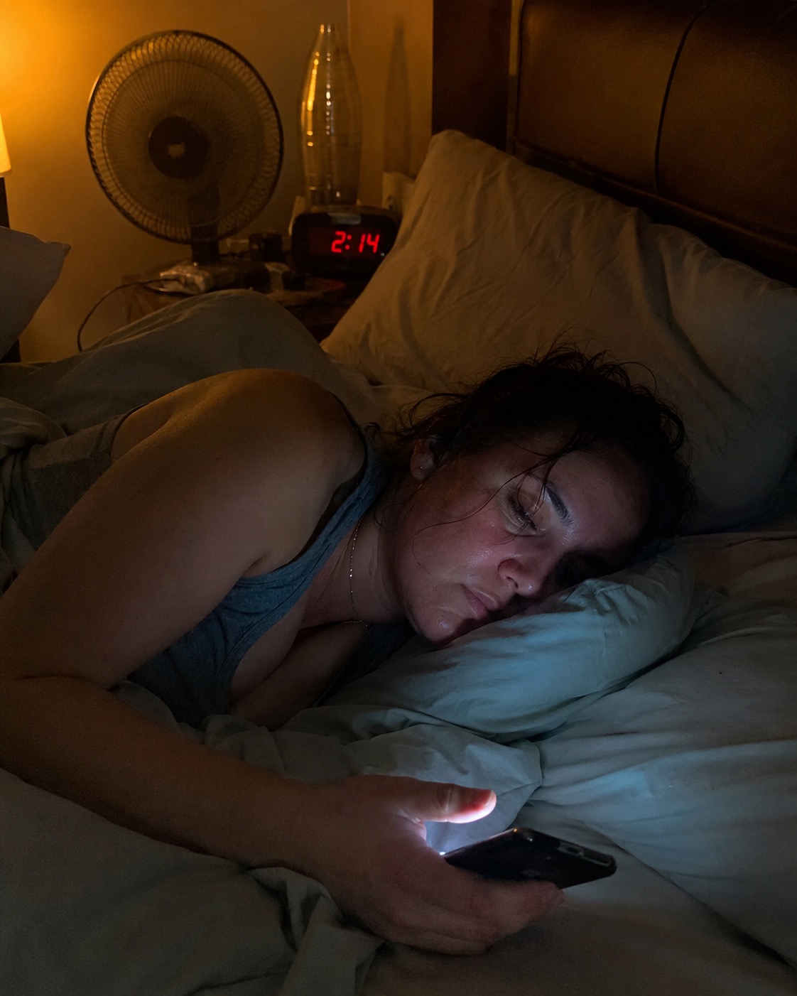 Woman awake at 2 AM in a hot bedroom